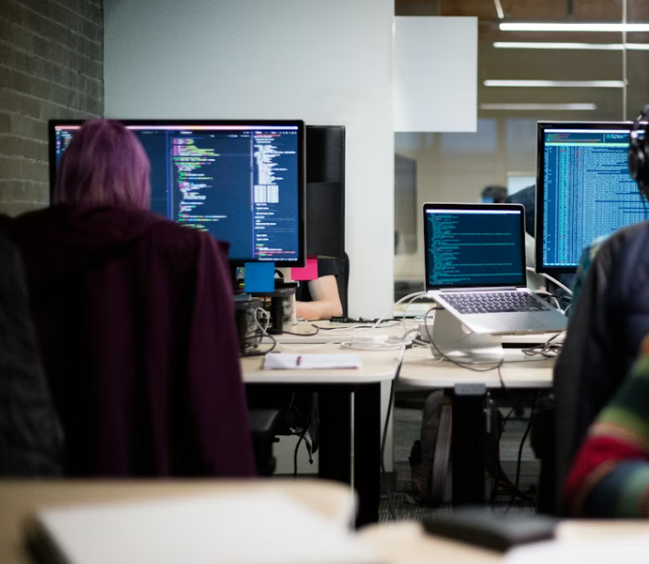 An office with developers working at several screens