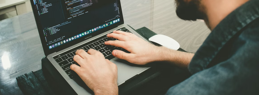 A person coding on a laptop